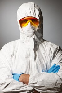 Scientist in protective wear, glasses and respirator